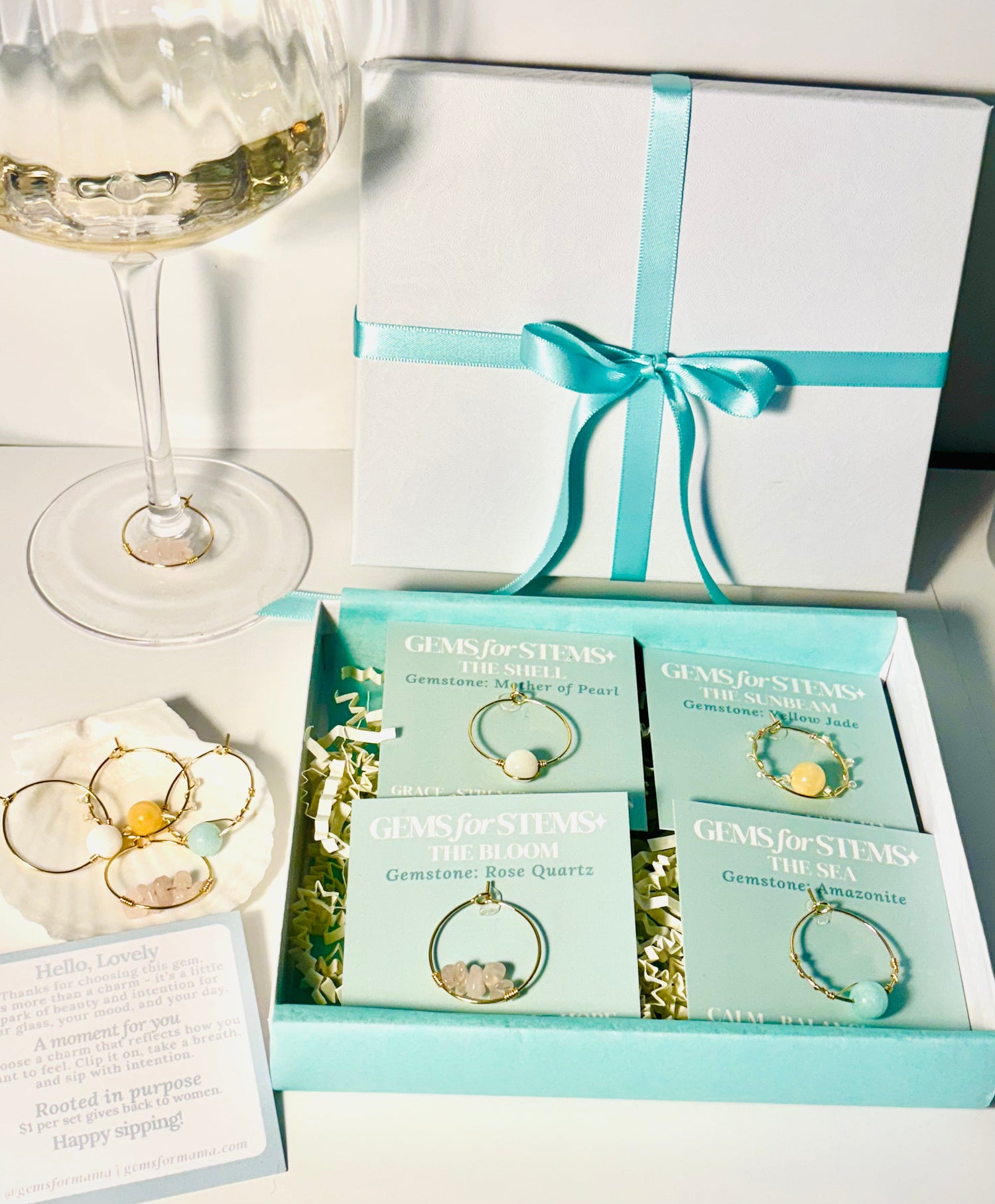 Intentional hand-crafted gemstone glass charms designed to celebrate presence, connection, and beauty - while giving back to women's causes.